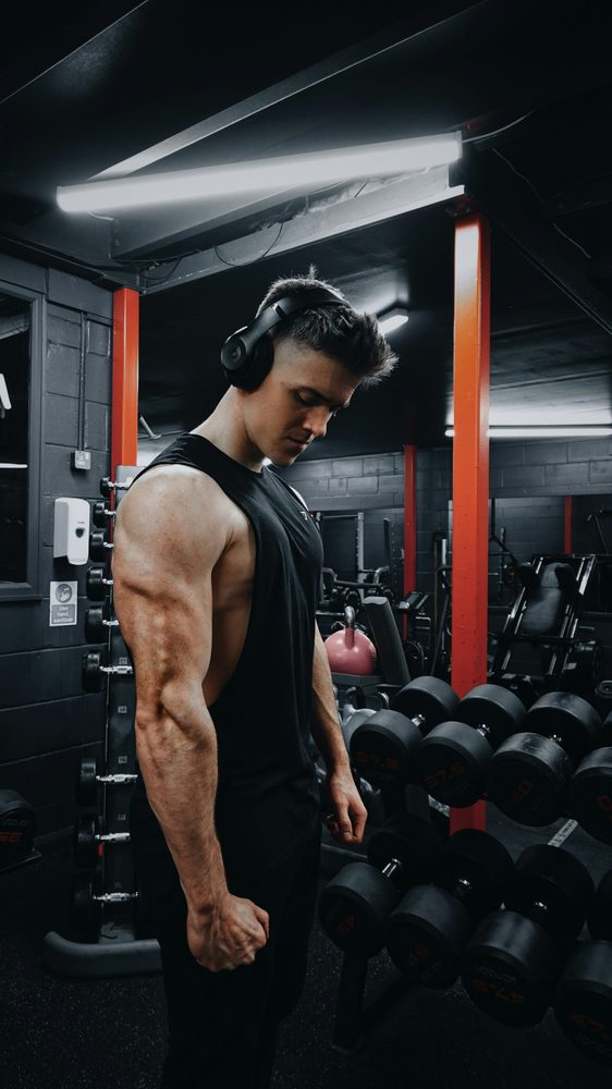Lifter resting between sets in a dark gym